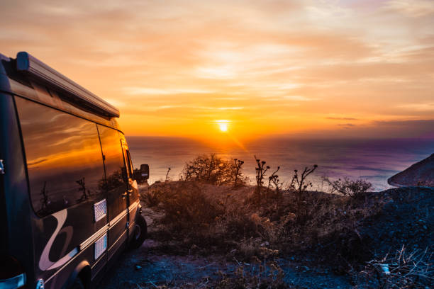 istock Camper car on nature at sunrise. Travel 998926450