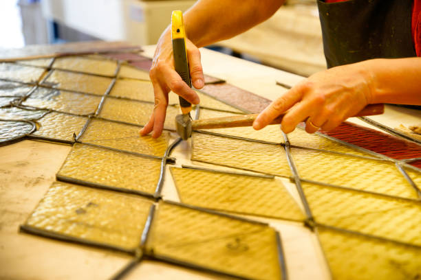 istock Master Glazier restoring antique glass wall 998932798