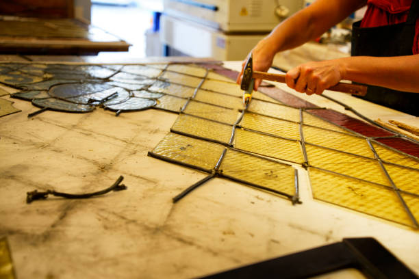 istock Master Glazier restoring antique glass wall 998932912