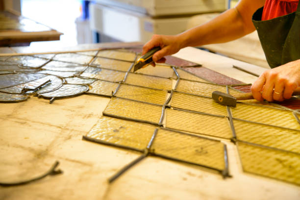 istock Master Glazier restoring antique glass wall 998932916