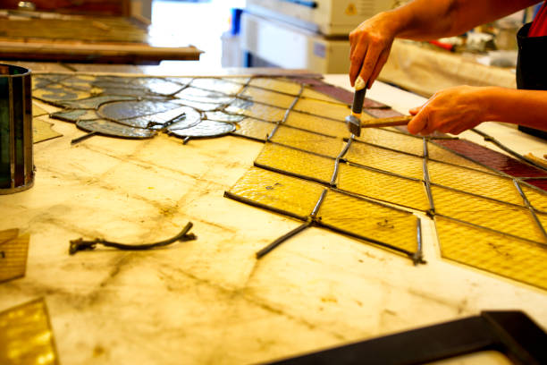 istock Master Glazier restoring antique glass wall 998932926