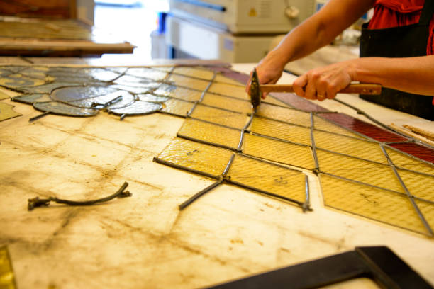 istock Master Glazier restoring antique glass wall 998932932