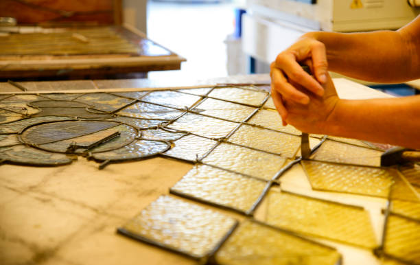 istock Master Glazier restoring antique glass wall 998932996