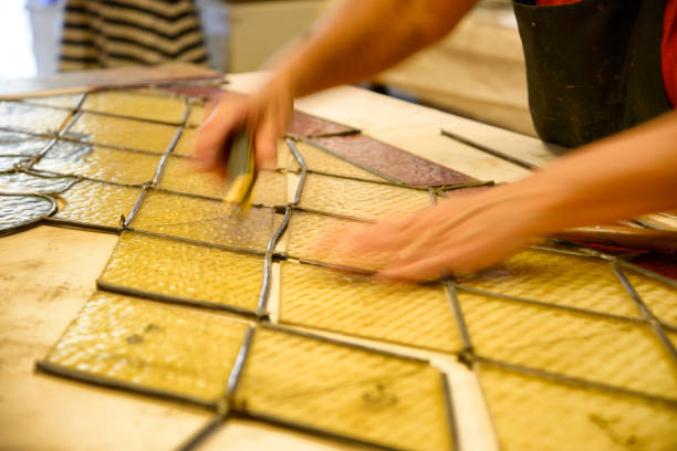 istock Master Glazier restoring antique glass wall 998933000