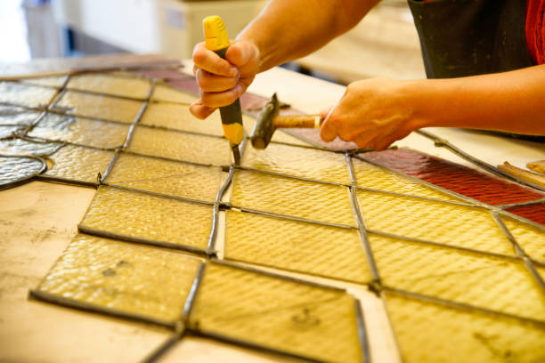 istock Master Glazier restoring antique glass wall 998933004
