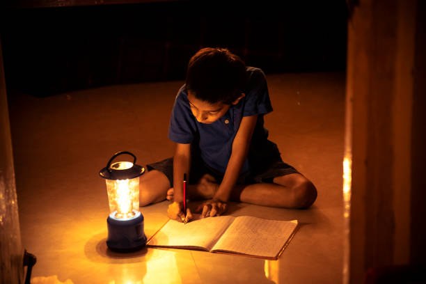 istock 7 years Indian Boy studying under lamp 998933468