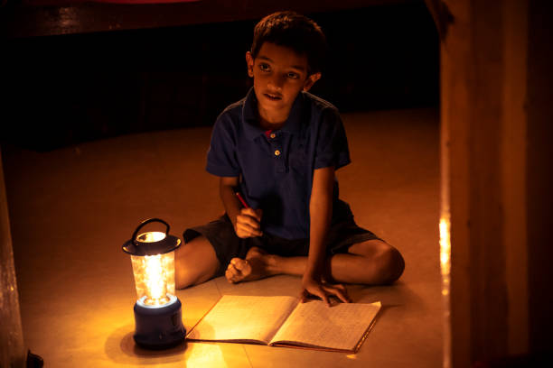 istock 7 years Indian Boy studying under lamp 998933470