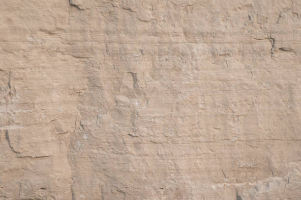 istock Wallpaper with limestone rock face showing weathered strata Geology background 998933662