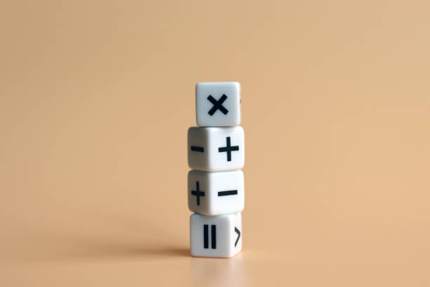 istock The stack of four dice with arithmetic operation symbols on soft orange background. 998933928