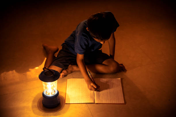 istock 7 years Indian Boy studying under lamp 998953778