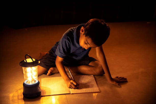 istock 7 years Indian Boy studying under lamp 998953788