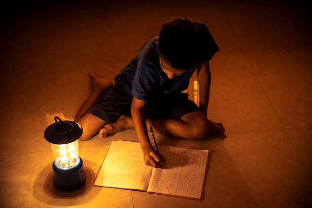 istock 7 years Indian Boy studying under lamp 998953790