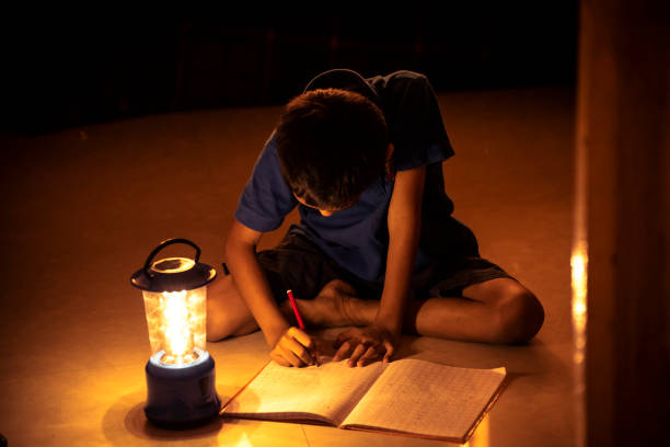 istock 7 years Indian Boy studying under lamp 998953826