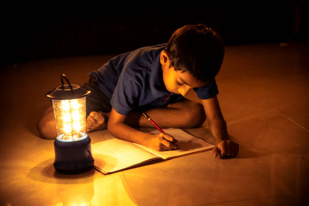 istock 7 years Indian Boy studying under lamp 998953878