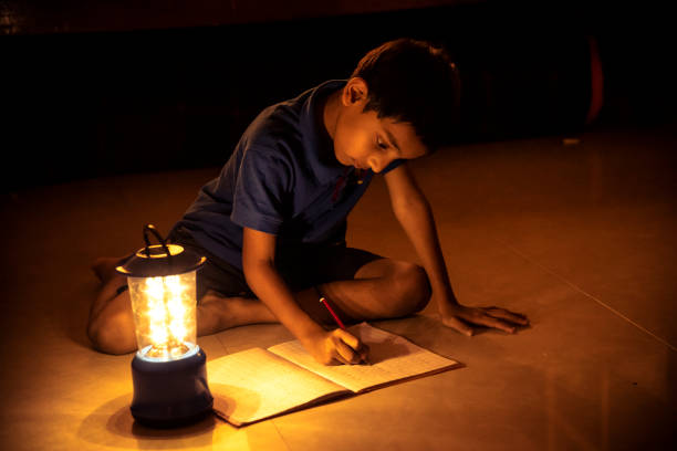 istock 7 years Indian Boy studying under lamp 998953880