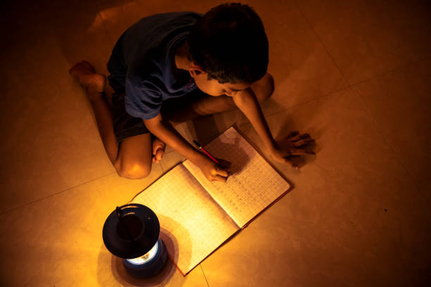 istock 7 years Indian Boy studying under lamp 998953886