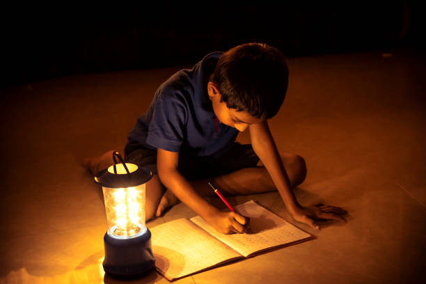 istock 7 years Indian Boy studying under lamp 998953894