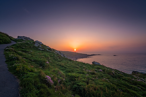 Walking path along the Cornish coast at sunset, St. Ives, Cornwall, England