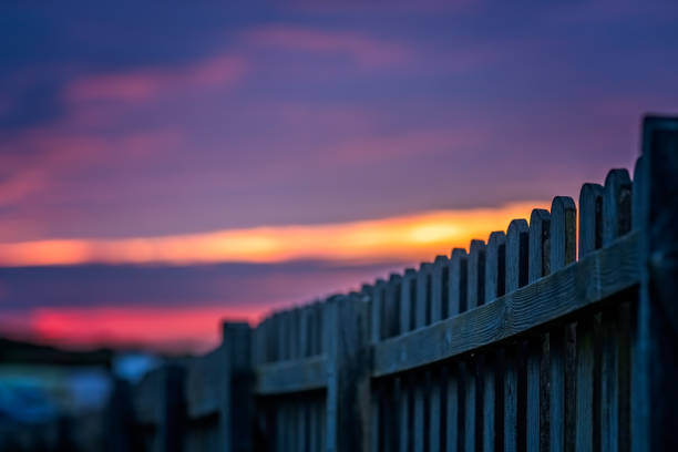 Wooden fence and the beautiful sky at sunset over the Cornish coast, St. Ives, Cornwall, England