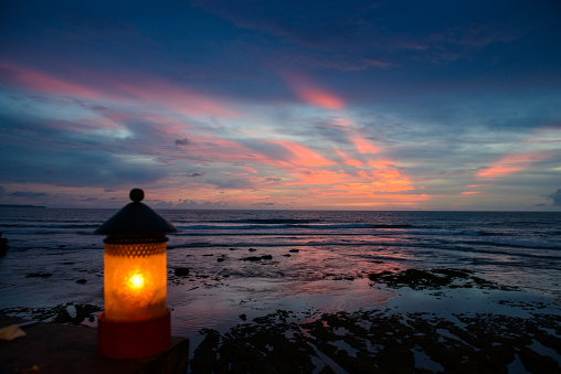 Bali, Indonesia - Coast of the tropical sea with a beautiful lamp at sunset