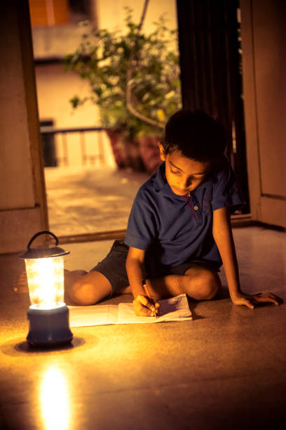 istock 7 years Indian Boy studying under lamp 998960716