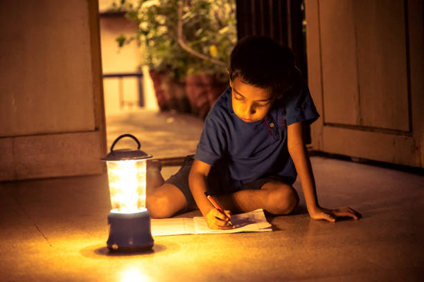 istock 7 years Indian Boy studying under lamp 998960736