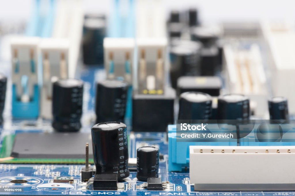 Electronic board. The board features elements: chips, diodes, capacitors, chokes. Shallow depth of field. Can be used as a background. There is a place for an inscription. Abstract Stock Photo