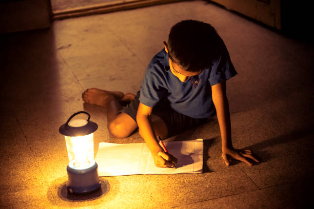 istock 7 years Indian Boy studying under lamp 998964114