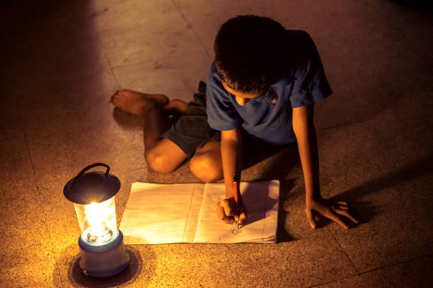 istock 7 years Indian Boy studying under lamp 998964118
