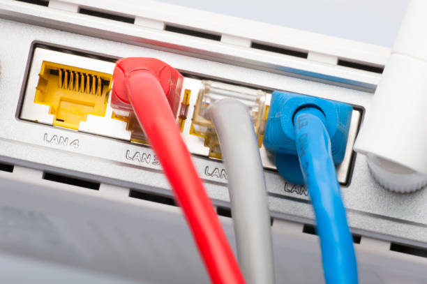 istock Modem router network hub with cable connecting. Bright blue and red cables and connectors. 998964238