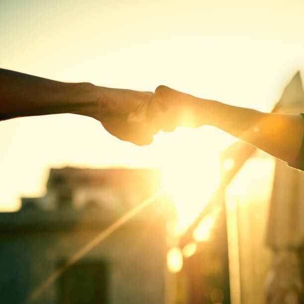Silhouette of open hand and sunny sky