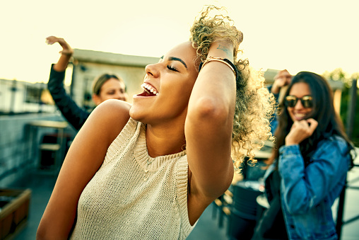 Shot of a group of young women dancing and having fun together outdoors