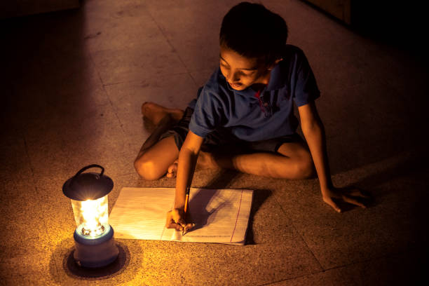 istock 7 years Indian Boy studying under lamp 998976062