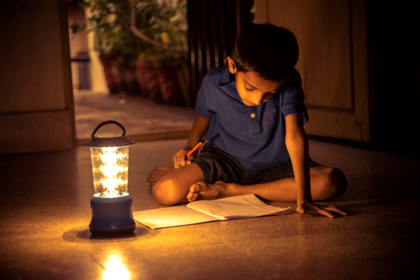 istock 7 years Indian Boy studying under lamp 998976082