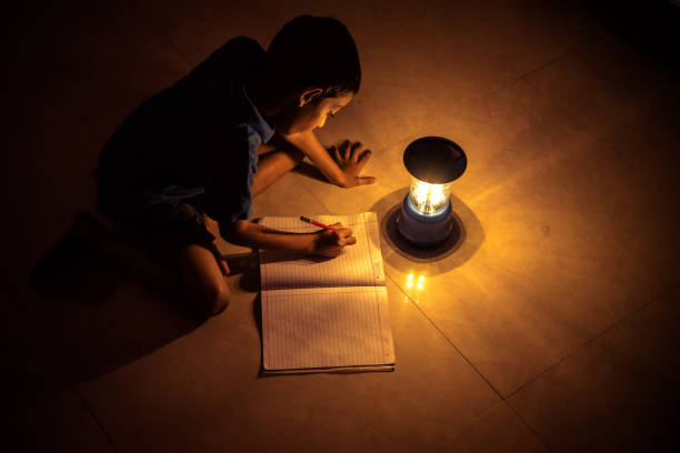 istock 7 years Indian Boy studying under lamp 998976114