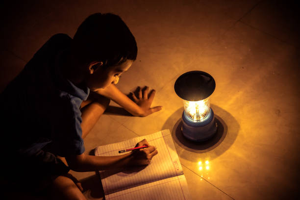 istock 7 years Indian Boy studying under lamp 998976168