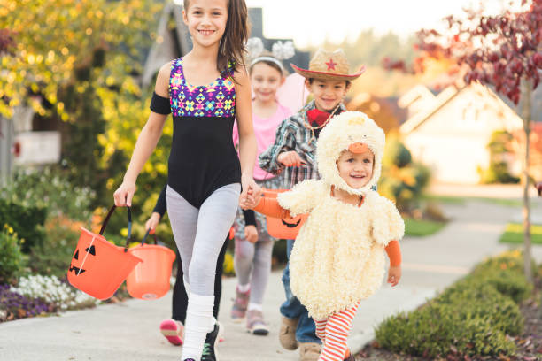 istock Multiethnic group of kids trick or treating 998983166