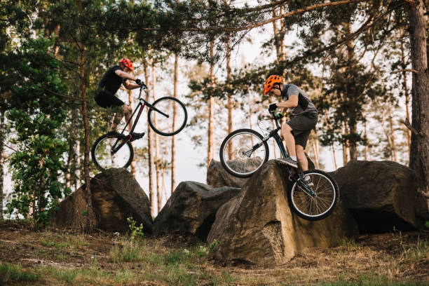 istock extreme trial bikers performing stunts on rocks outdoors 998984042