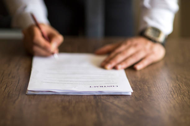 Close up business man signing contract