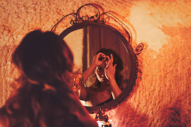 istock Woman making make-up near mirror 998993976