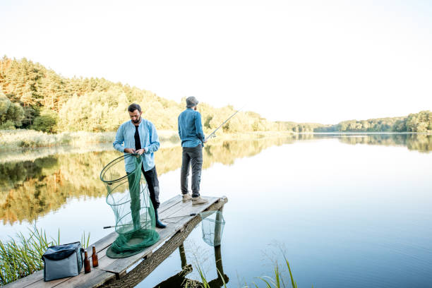 istock Men fishing on the lake 998996920