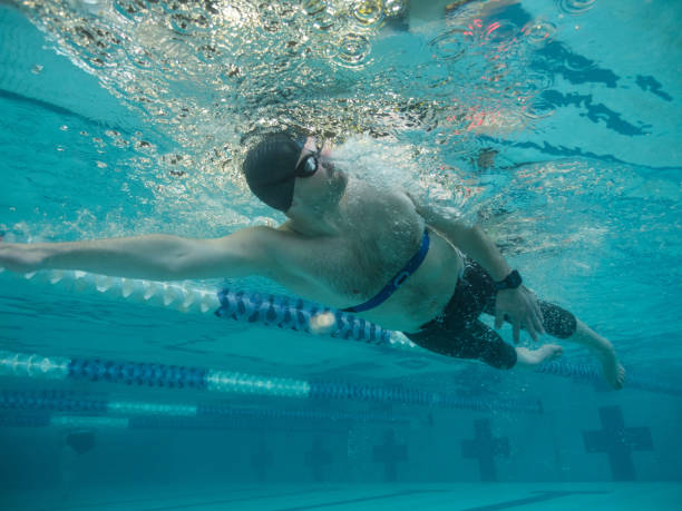 istock Adaptive athlete swims laps in a pool 998997440