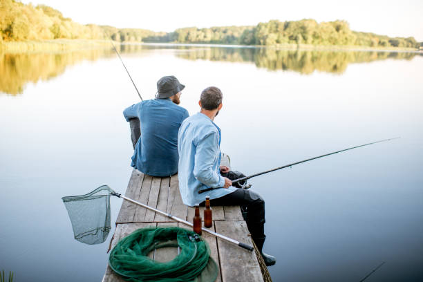 istock Two men fishing on the lake 998997628