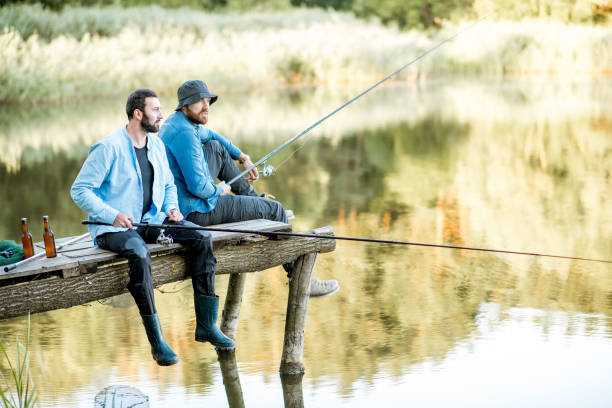 istock Two men fishing on the lake 998997760