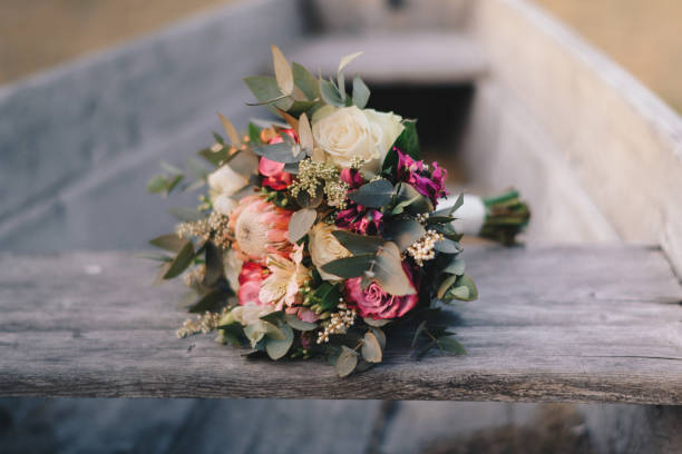 istock Wedding bouquet on wooden boat 999001632