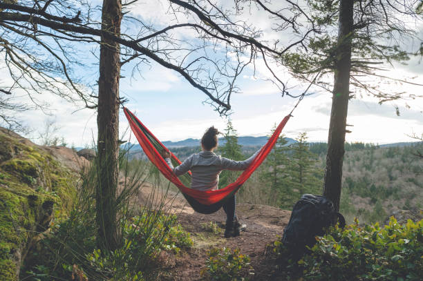 istock A young woman relaxes in a hammock in the forest 999017656