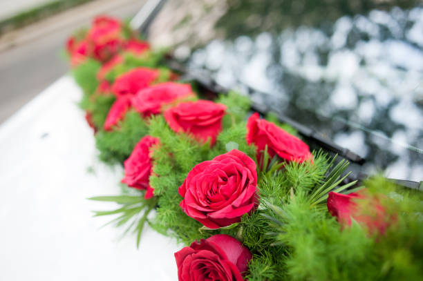 istock Red rose floral decorations on wedding car 999027042
