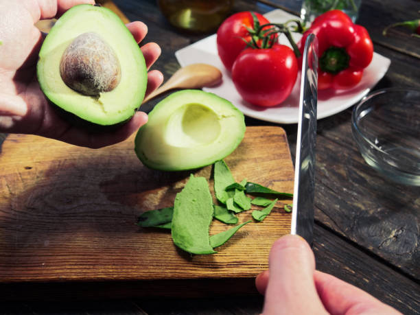 istock Cutting and peeling avocado for salad 999033504