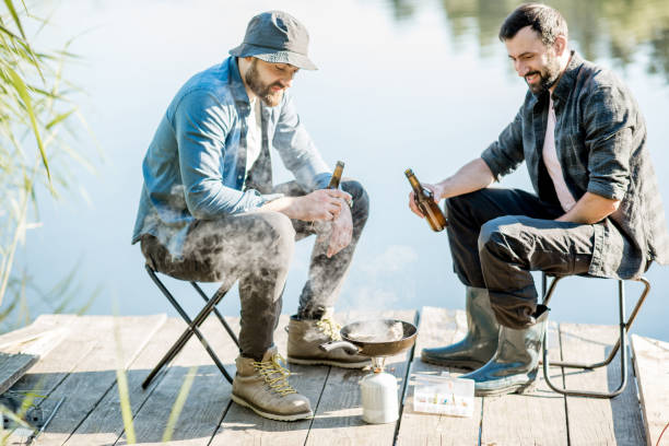 istock Fishermen frying fish outdoors 999034976