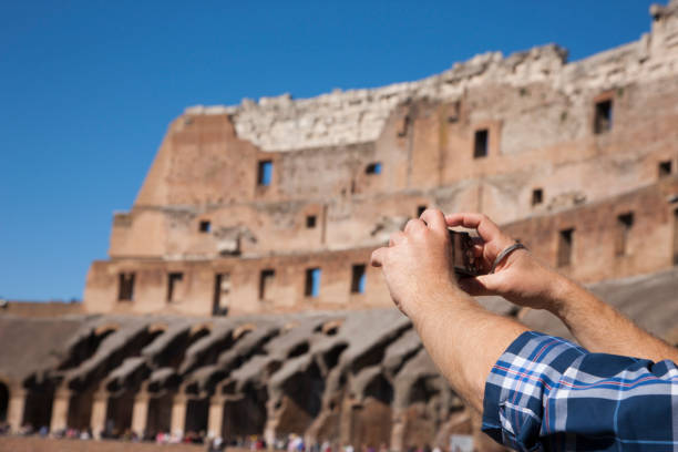 istock Hands with a camera On a blurry background Colosseum 999073466